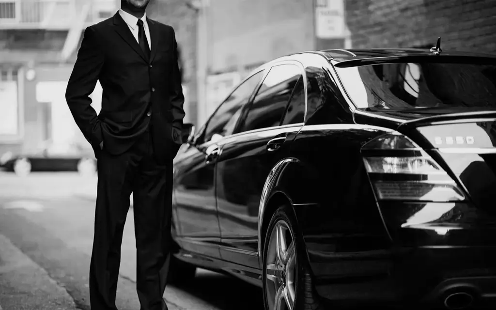 Luxury chauffeur opening car door in Tokyo